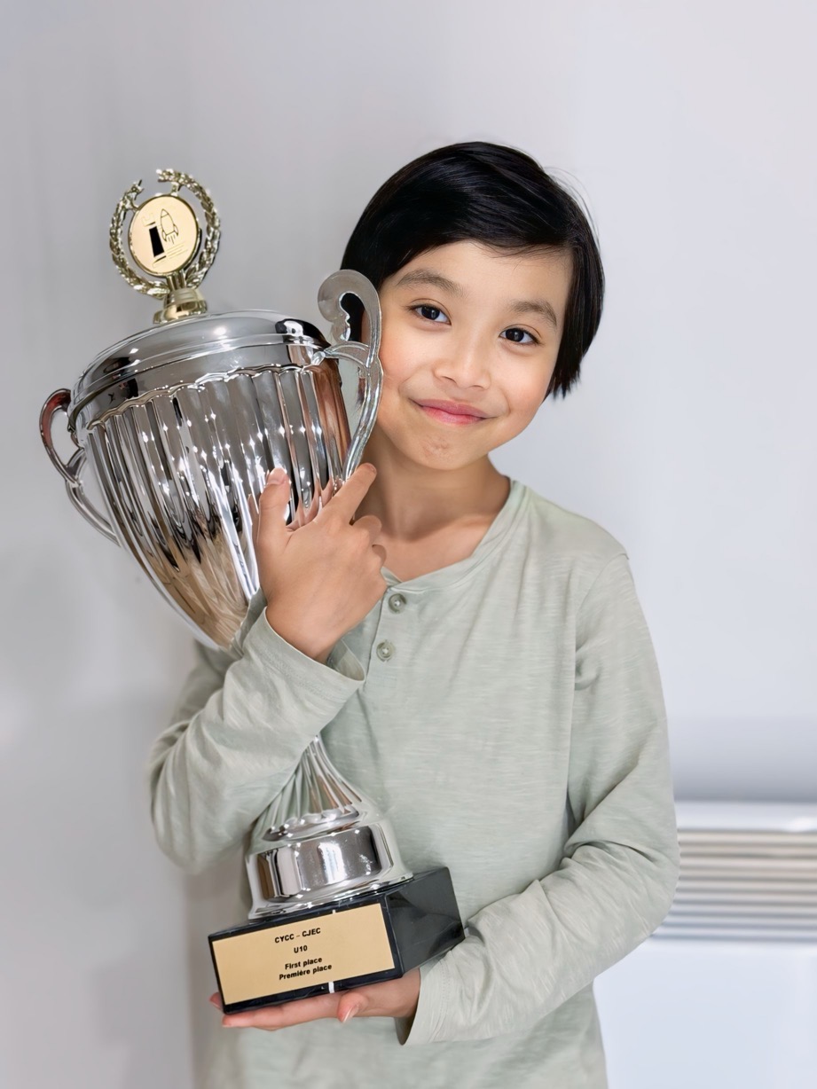 Lucas Yao holding a silver chess trophy