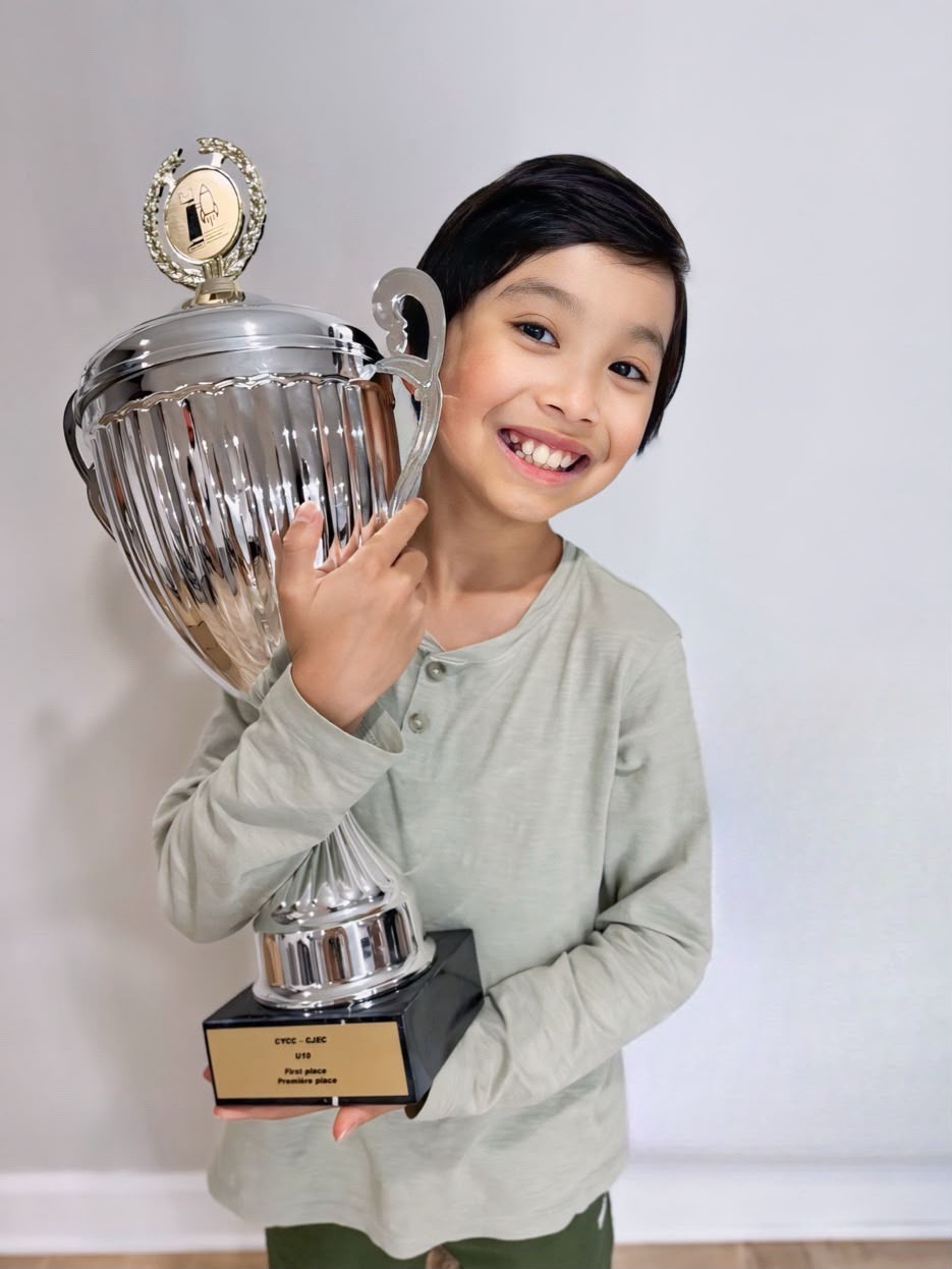 Lucas Yao holding his first-place trophy from the Canadian Youth Chess Championship