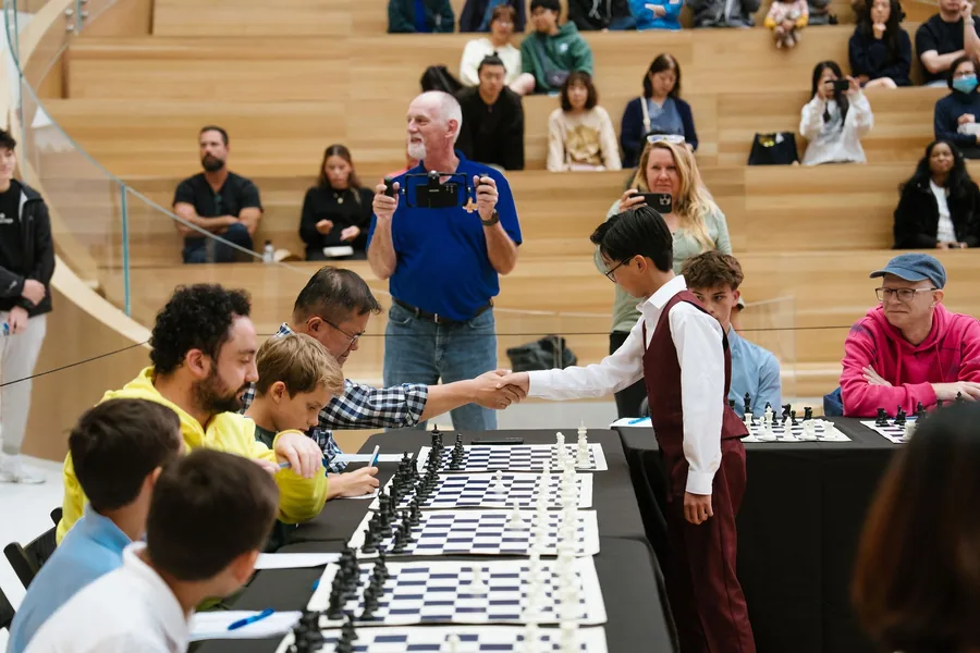 Lucas Yao shaking hands with an opponent at the Oakridge Park simultaneous exhibition